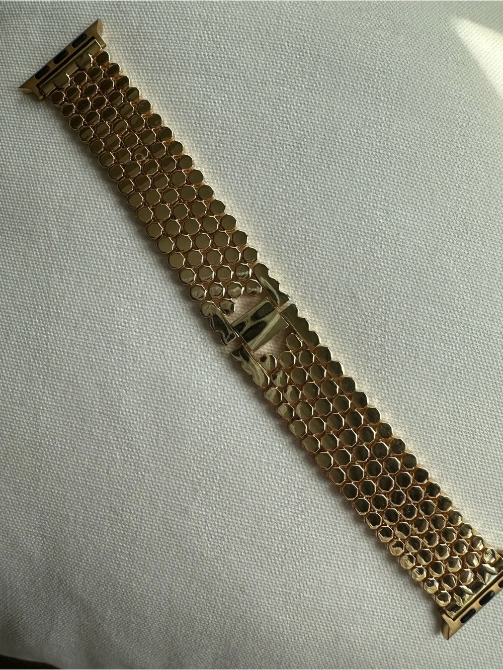 Honeycomb stainless steel strap in gold tone for Apple Watch.